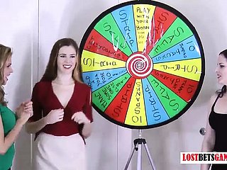 3 very alluring girls law a amusement of platoon spin a catch wheel